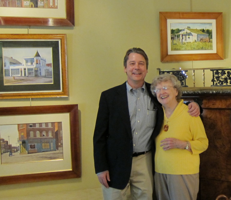 Robert Morrissey, owner of Clark Graves Antiques in Clayton, with Carlene Masters during a show there of Stan's paintings. 