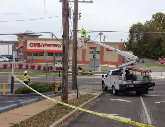 A Charter crew raises the downed wires back up to existing poles.