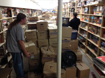 The Book House employees Dave Simmons and Justin Wingerter move boxes of books in the basement. The store is trying to open by Black Friday.