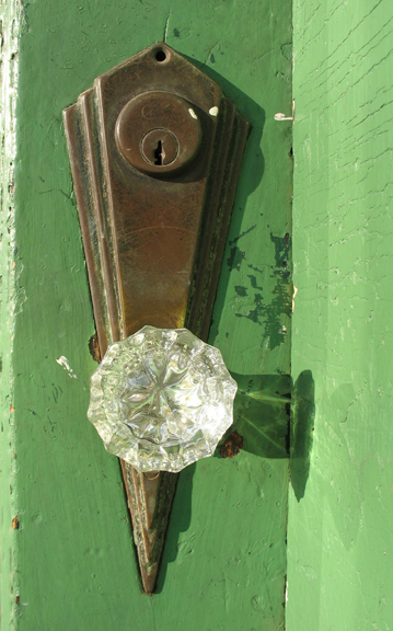 Pretty cool Art Deco doorknob and escutcheon on the door leading to the upstairs. Zillow gives a construction date of 1928 on this building.