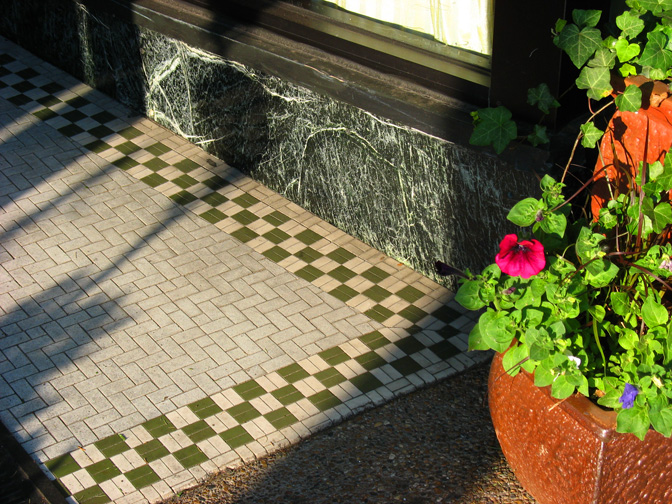 The basket weave field with a checkerboard border backed up by a nice piece of serpentine marble make for a very attractive entryway.