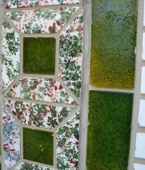 A closeup of the green glazed brick with paired with a glaze that looks to me like mortadella (or am I just hungry?).