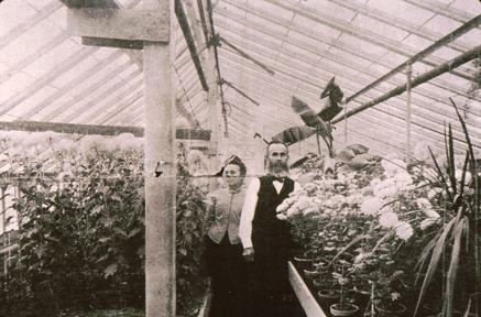Mr. Stertzing and wife in the greenhouse that was once attached to their building.