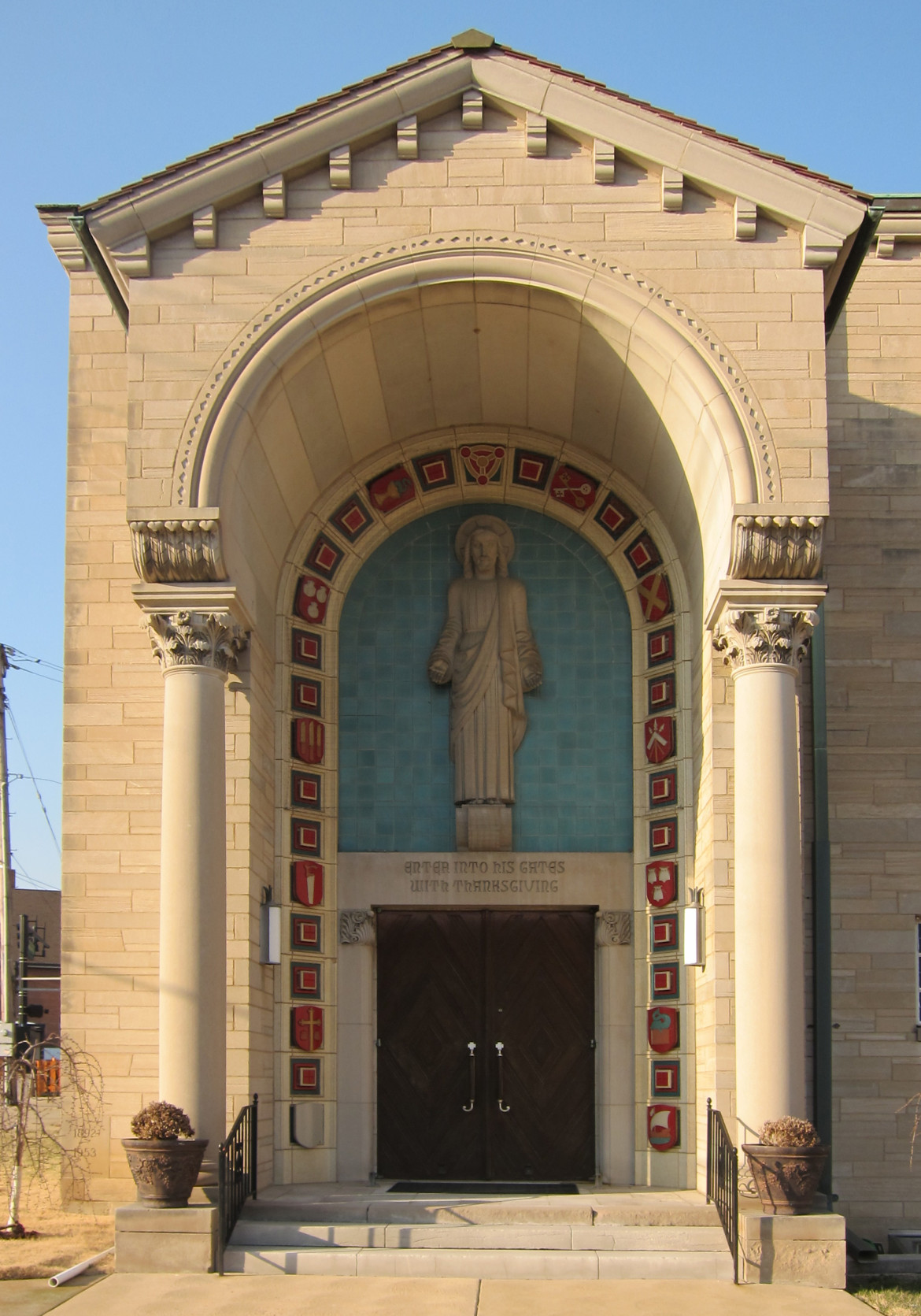The main entry surrounded by Christian symbols.  According to Esley Hamilton, the St. Louis County historian, it is unusual for a Protestant church to display as much symbolism as Concordia does.  