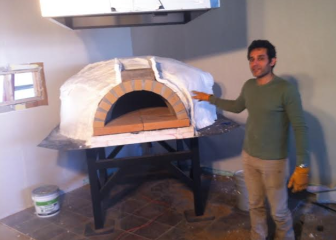 Muhammad Alhawagri with his wood-fired oven for A Pizza Story, in Maplewood.