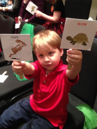 JK3 student Paul D. displays the signs participants used to indicate the speed of the music they were hearing.