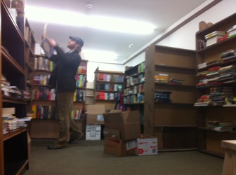 Book House employee Ben Rosensweig shelves books.