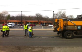 County workers fill potholes on Brentwood Boulevard.