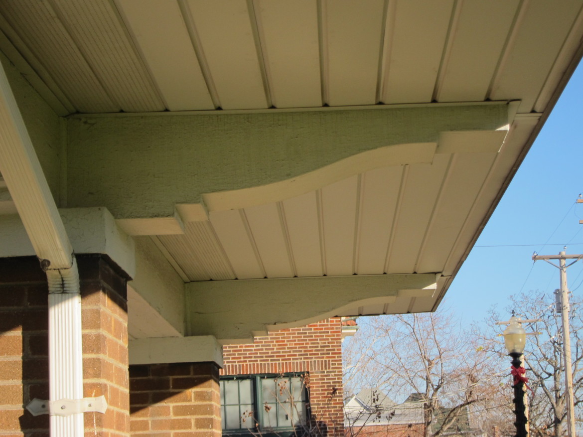 These large graceful brackets will look so much better once the aluminum soffit is removed and an original style of soffit most likely made of bead board is installed.