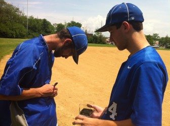 Coach Jonathan Webb signs a game ball given to him by senior Rich Rasmussen.