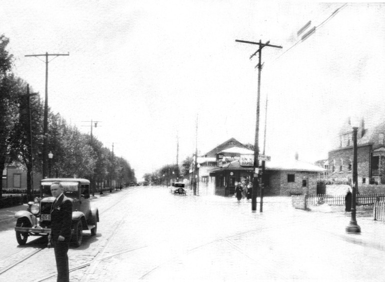 The seventh and last section is looking south on Sutton.  the same house is visible at each end of the photograph.  The building advertises Barbe-Q. It is now home to Krodinger Realty.  The brick barbecue pit cna still be seen along the sidewalk sans chimney.  Regular viewers of this space may remeber that harper's Pharmacy gradually morphed into a full time camera store.  I suspect this photographer (possibly salesman) may have been demonstrating equipment to the Harpers.  If you have a better theory, let's hear it.