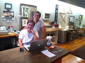 Patti Brightfield (sitting) and Nancy Kassabaum, with Penny Dreyer (not in photo) are co-owners of Roots.