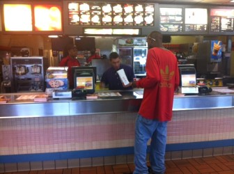 McDonald's Manager, Nick Muchitello (center) serves a customer Monday afternoon.