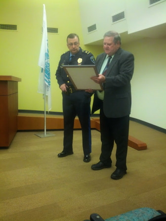 Maplewood mayor James White presents an Award of Excellence to police Sgt. Michael Martin