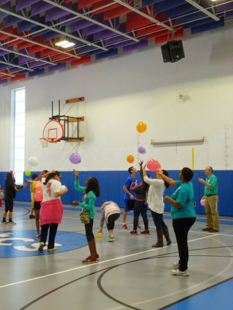 Area middle school students experience team building and problem solving by keeping balloons in the air.