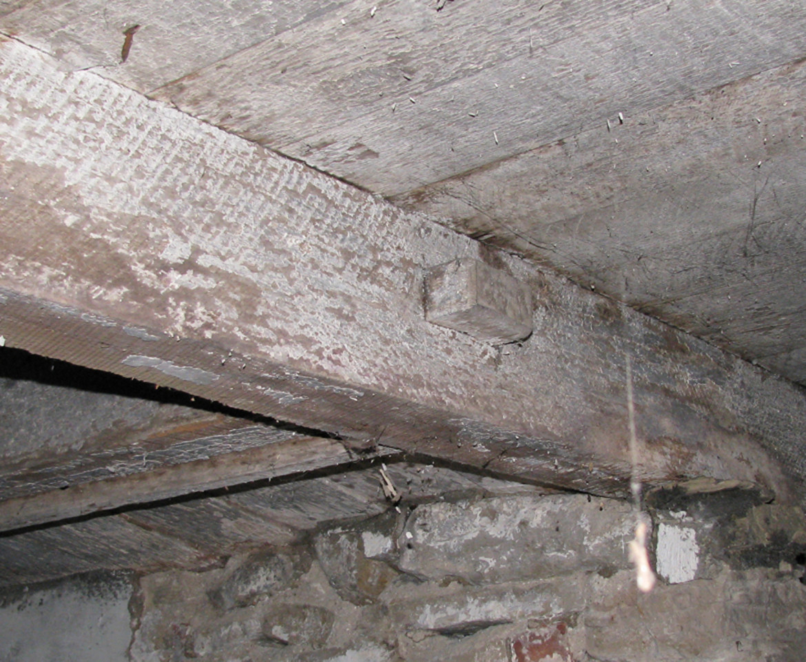 A mortise and tenon joint underneath the eastern hearth on the first floor.
