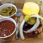 A Dickey's pulled pork sandwich with two sides.
