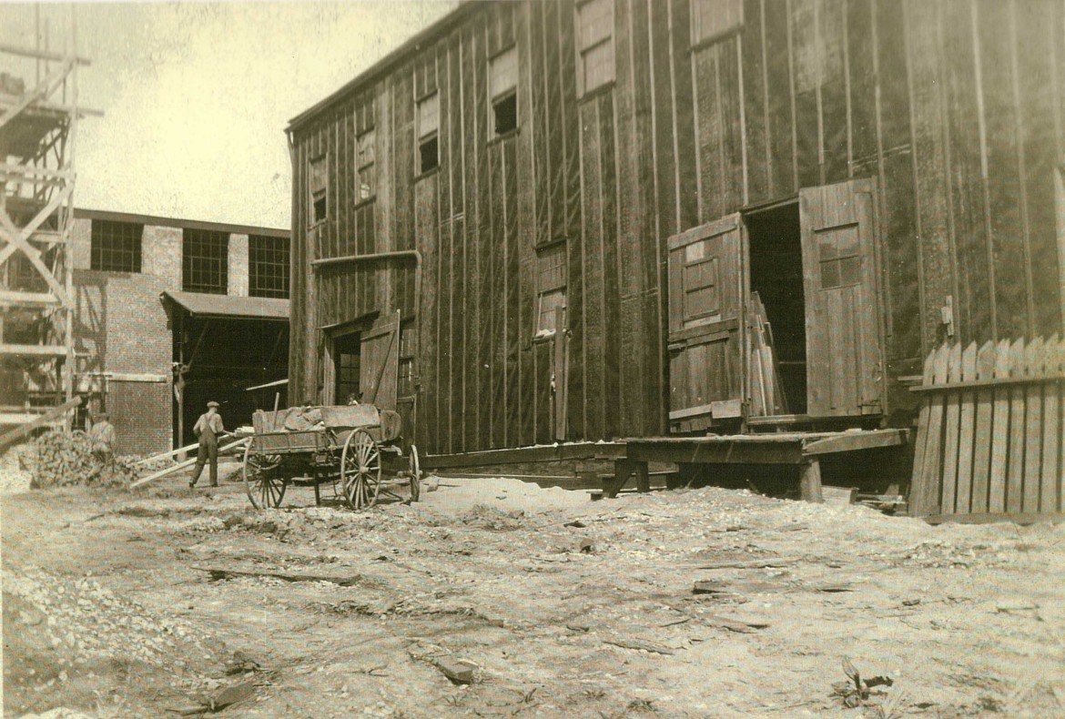 The first mill building covered in tarpaper in the foreground.  The second mill building is being constructed in the rear.  About 1926.  Courtesy of Alan Blood.