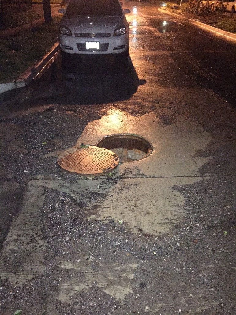 Flooding on Yale Ave. A storm sewer cover was pushed off the opening. Photo by Matt Coriell