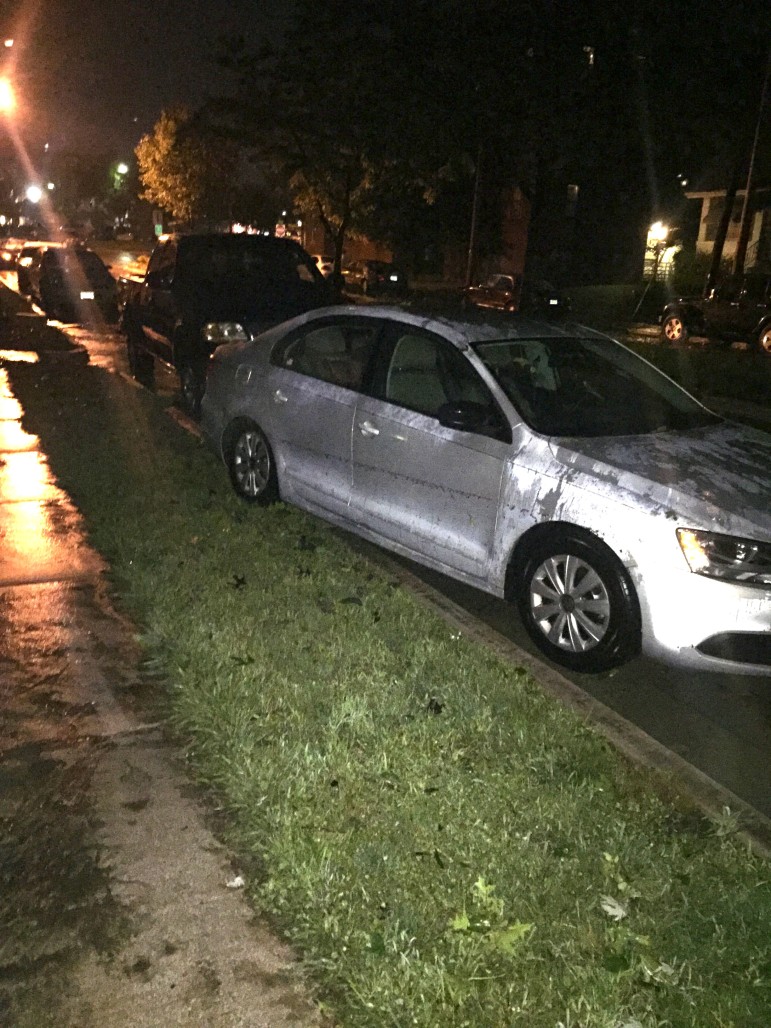 Flooding on Yale Ave. A car was floated onto the curb. Photo by Matt Coriell