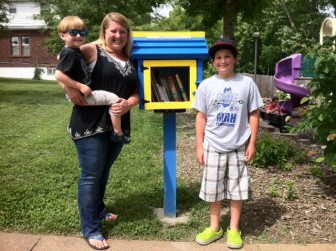 Nicole Skaggs with her sons, Cooper and Carson with the library in Highland Park, in Richmond Heights.
