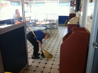 Mabel Lewis sweeps the floor for the last time at the Maplewood White Castle.