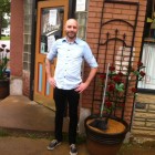 Cedric Aubuchon, general manager of Southwest Diner at the entrance, after the flood receded.