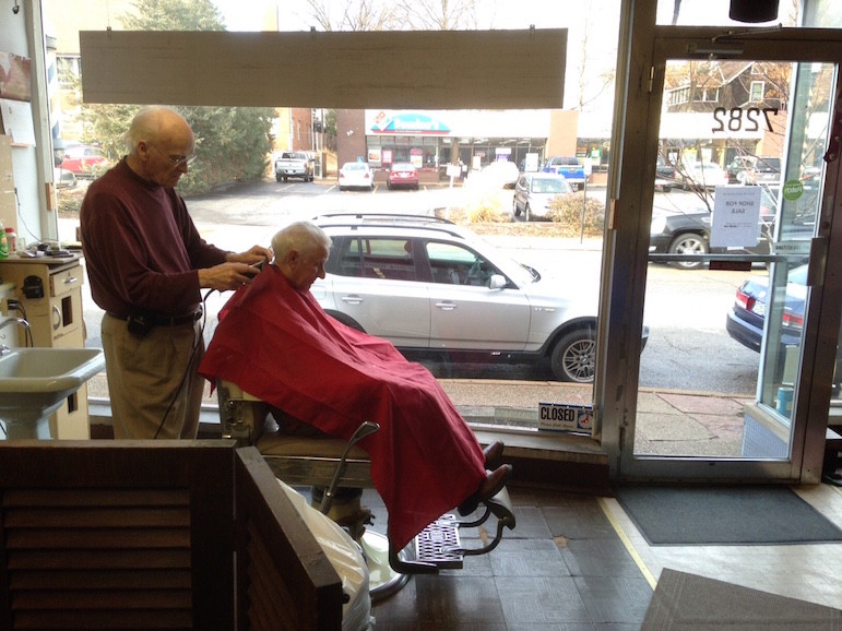Maple Leaf barber, Stan Chenoweth gives one of his last haircuts.