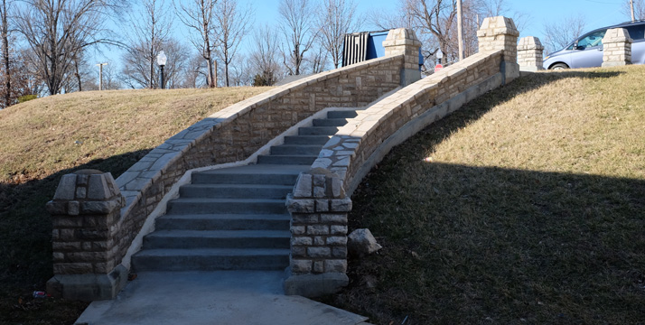 The curvaceous stairs on the western side of the building. There are two of what I'm calling stone bollards at the top of the steps. there are more on site at what now seem like odd locations.