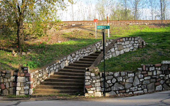 These beautiful curving stairs at Maple and Arbor once led to the Maplewood train depot which was called, curiously enough, the Maplewood depot. The construction is rubble. It is interesting because the masons also included granite cobblestones along with the limestone. Having found cobblestones at an earlier depot site in Maplewood, my guess is that they used them because they had them around. These stairs are a wonderful detail of one of our oldest neighborhoods. Hopefully someone will keep them pointed up so they're not gradually lost rock by rock. since they are on the property of the railroad, one might want to just go ahead and do it rather than try and wade through the predictable bureaucracy that would weigh the merits of any official requests.