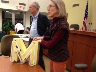 Heather Testa, of Ten 8 Group, with an M from the Maplewood Theatre.