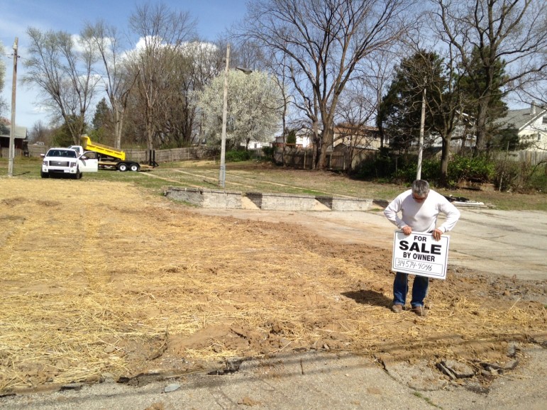 Elmer Teson straightens a for sale on the site of the former Teson Farms, in Brentwood.