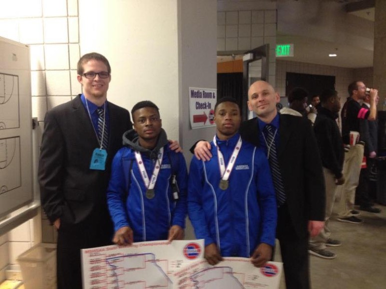 Ronald Stewart (center left) and Romelle Person (center right) after the state meet as juniors with MRH state placer Brandon McClure (left) and Coach Cory Reichert.