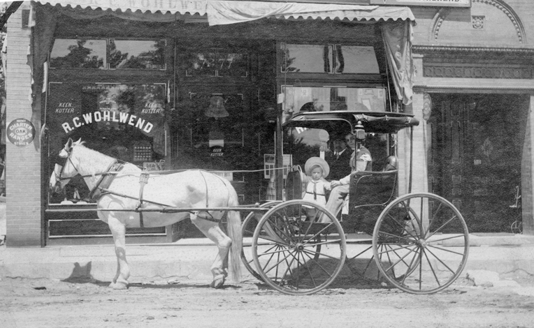 Rosa and Emil L. Scheidt posing with their handsome rig in front of their first store in the 7200 block of Manchester. Opened in 1907, they moved to the current location at 7320 Manchester in 1916. The boy is Emil C. Scheidt who would grow up to run the hardware store until the operation was taken over by his son, Bob, who is still involved today.