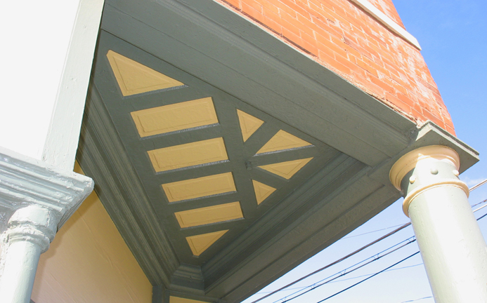 A super cool triangular paneled ceiling on the corner entry.